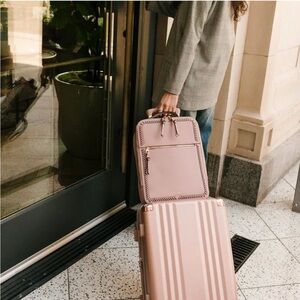 Calpak Pink Laptop Backpack with Whipstitch Detailing and Tassel Charm